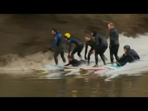 Surfers catch big tidal wave on British river