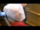 Accused man appears in court wearing spit guard
