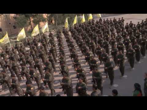 SDF forces parade during a ceremony announcing their victory over IS