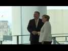 Mike Pompeo and Angela Merkel shake hands at the German chancellery