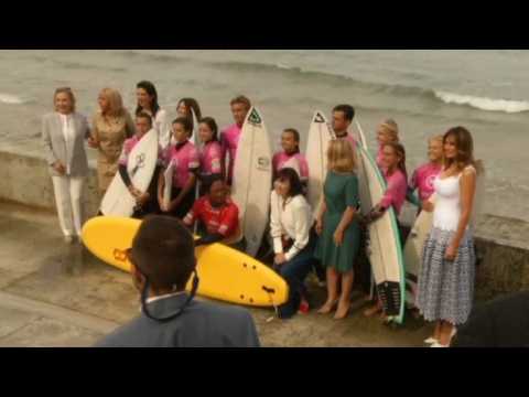 Spouses of G7 leaders meet young surfers on Biarritz beach