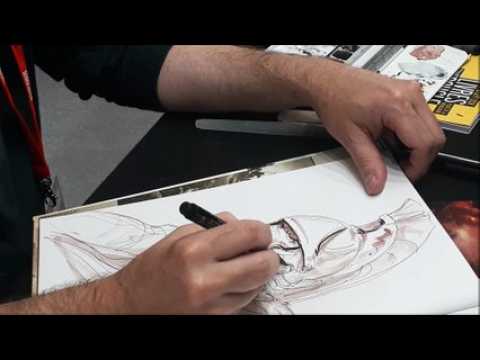 Alain Brion, auteur d' "Excalibur-chroniques",  dédicace une de ses BD pour un fan