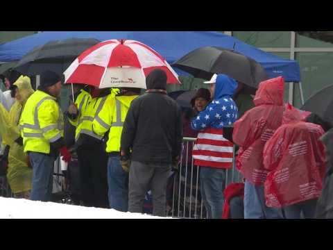 Supporters line up in the rain ahead of Trump's rally in New Hampshire