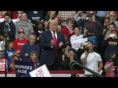 Trump arrives at campaign rally in New Hampshire on the eve of vote