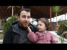 Syrian father and three-year-old daughter laugh off the shelling