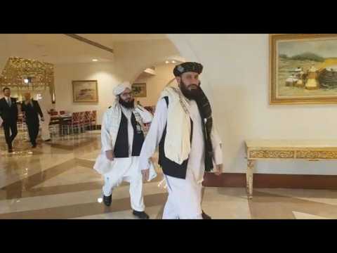 Taliban negotiators arrive for the signing of the agreement with Washington