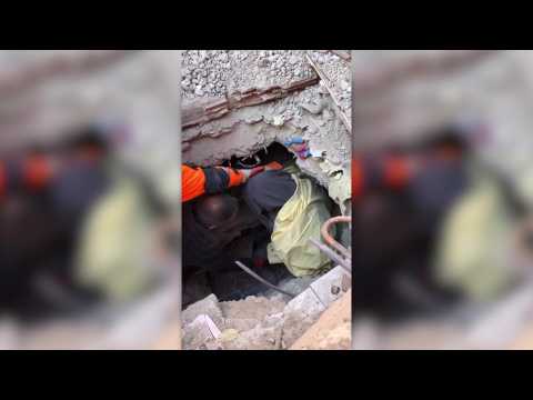 Turkish aid workers pull woman from collapsed building
