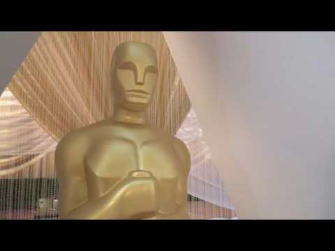 Tourists walk along Hollywood Boulevard as Oscars preps continue