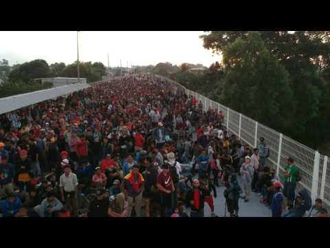 Thousands of migrants await to enter Mexico legally on border bridge