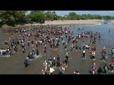 Migrants wade across river, crossing into Mexico from Guatemala
