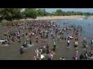 Migrants wade across river, crossing into Mexico from Guatemala