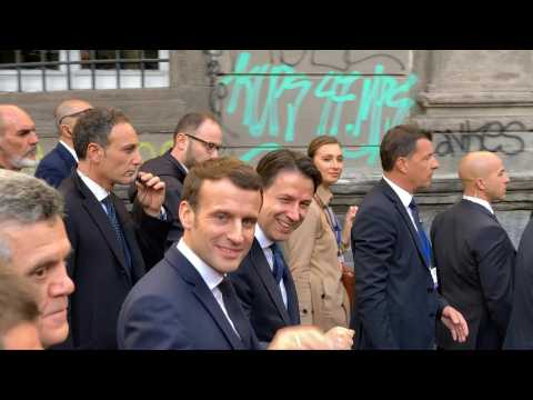 Giuseppe Conte and Emmanuel Macron walk through Naples historic centre
