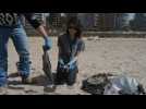 Volunteers remove tar from beach in Beirut