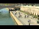 Parisians enjoy sunshine on the banks of the Seine