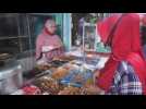 Vendors in Bali serve customers iftar food during Ramadan