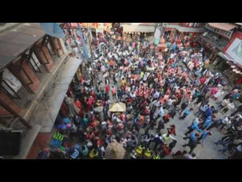 Thousands of devotees take part in a procession honoring the rain god in Kathmandu