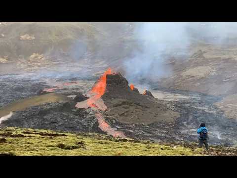 Red lava continues to spew from Icelandic volcano