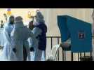 Electoral workers wear PPE at drive through polling station for quarantined voters