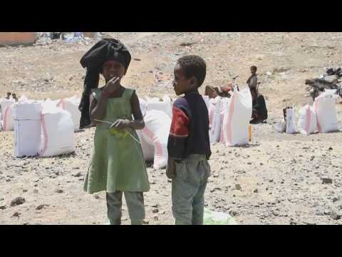 Yemenis receive food in a camp for internally displaced persons in Sana'a