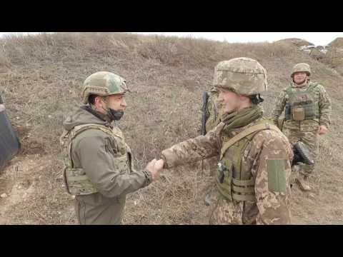 Ukraine's Zelensky on frontline as Merkel urges Putin to pull back troops