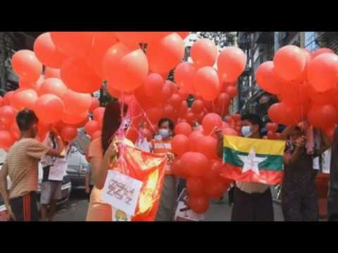Protesters release red balloons during anti-coup protest in Yangon