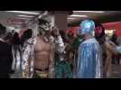 Mexican wrestlers distribute face masks in subway