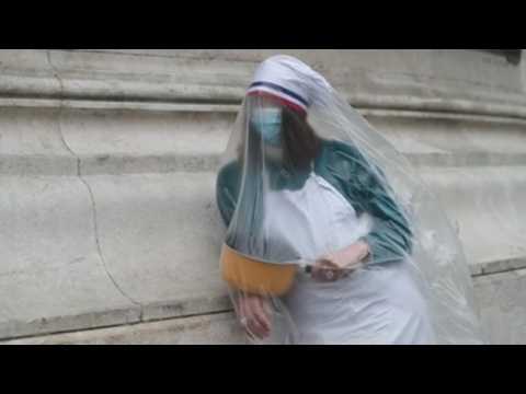 Protesters covered in plastic bags at demonstration against business closures in Paris