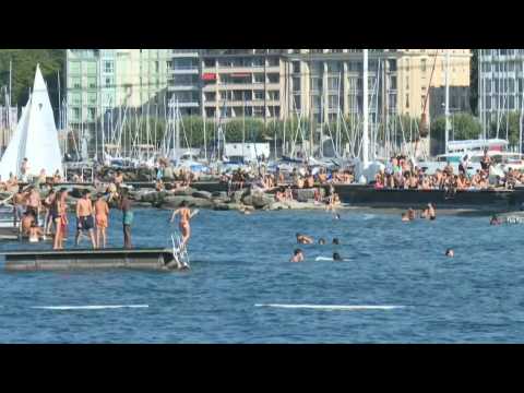 People cool off at Lake Geneva as temperatures soar in Switzerland