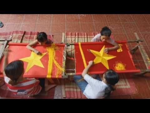 Vietnamese village famous for embroidery makes national flags ahead of Independence day