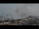 Firefighters continue to extinguish small fires at the Beirut port