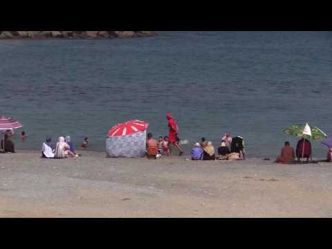 Algerians return to beaches, mosques despite pandemic