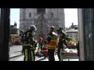 Fire fighters outside Nantes cathedral after blaze was brought under control
