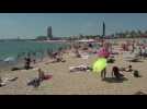 Crowds of people gather at Barcelona beaches