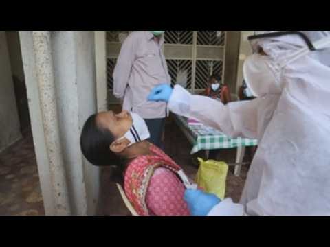 Health workers in Mumbai carry out COVID-19 tests