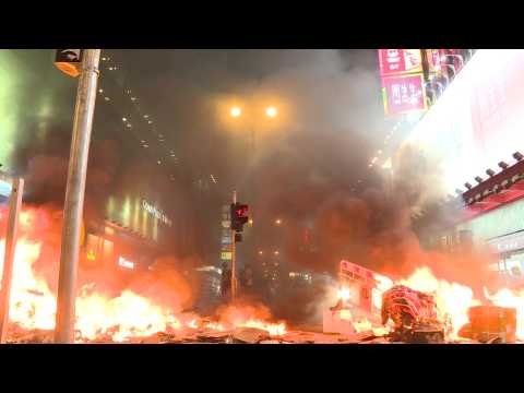 Hong Kong protesters set fire to road barriers in city's shopping district