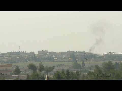 Smoke billows over the Syrian town of Tell Abyad, located just across the border with Turkey