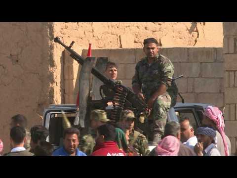 Syrian regime forces in Tall Tamr as they move towards Turkish border