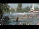 Water cannons try to disperse protesters in Santiago