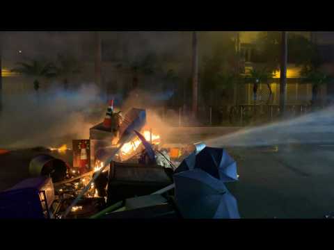 Water cannons used by HK police to put out fire lit by protesters