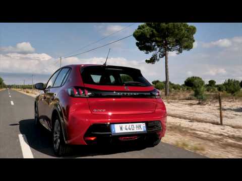 The new Peugeot e-208 Allure in Elixir Red Driving Video