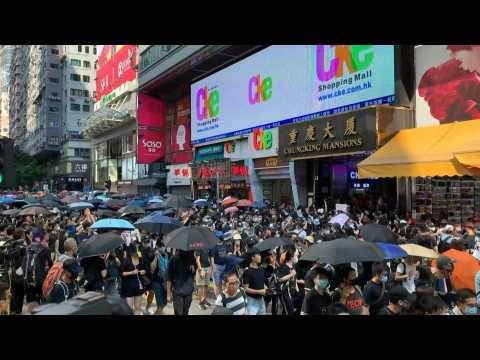 Democracy crowds defy Hong Kong police after activists attacked
