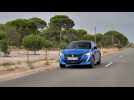 The new Peugeot e-208 GT in Vertigo Blue Driving Video