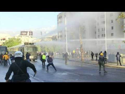 Chile protesters dispersed with water cannons as outcry continues