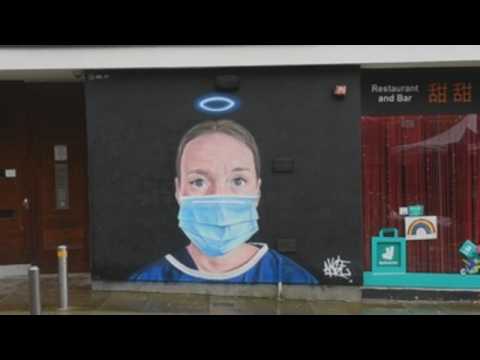 Manchester street artist honors health workers with large murals