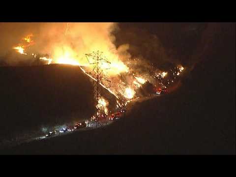 Firefighters battle out-of-control blazes in southern California
