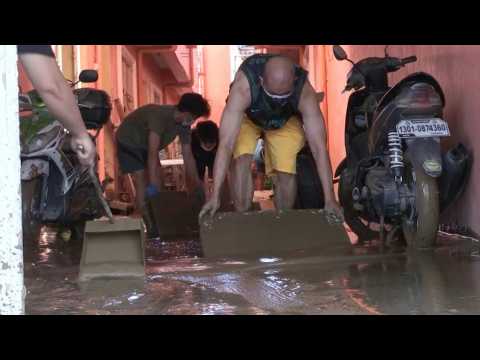 Manila residents clean mud-covered homes after Typhoon Vamco