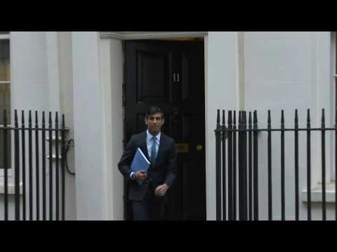 Britain's finance minister leaves Downing Street to deliver spending review