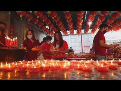 People pray for good fortune on Lunar New Year's Eve in Thailand
