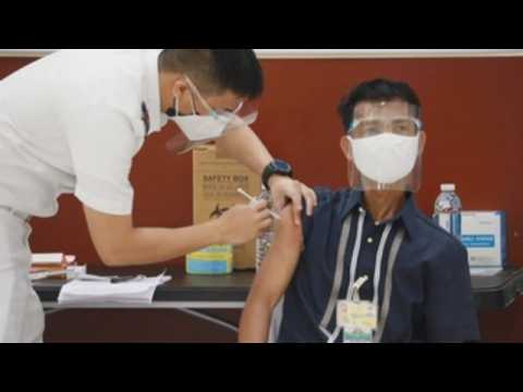 Philippine police vaccinated against COVID-19 on first day of vaccine rollout