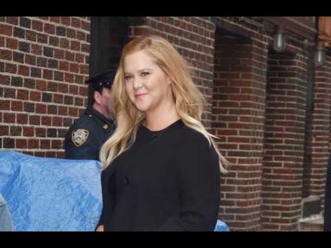 Amy Schumer confirms she is 'still pregnant and puking'